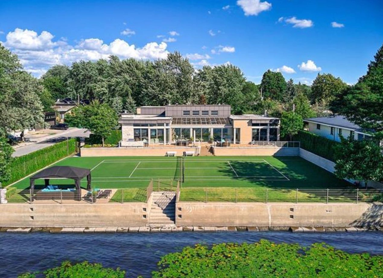 Waterfront property with a tennis court